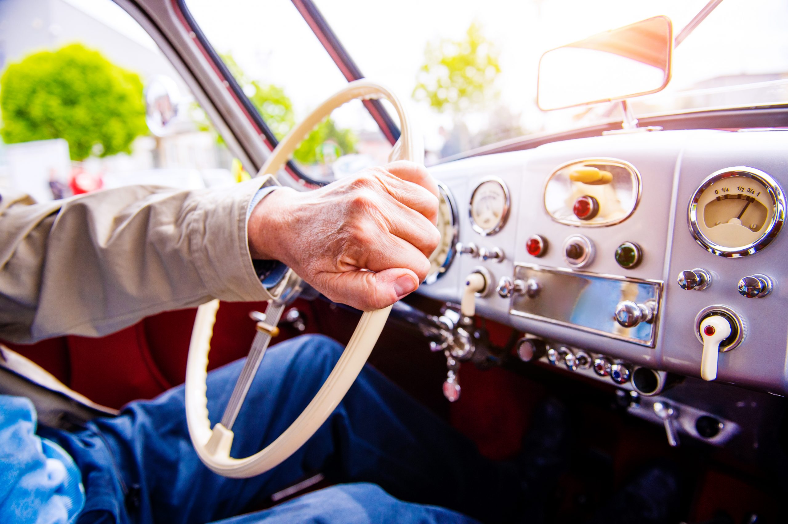 Close up unrecognizable man driving a veteran car